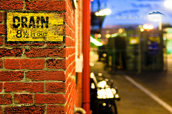 Drain Sign & Brick Wall